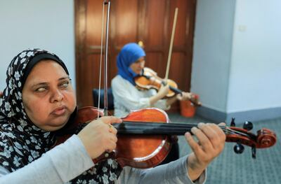 Members of Al-Nour Wal Amal (Light and Hope) chamber orchestra of blind women play violins during a practice session as they prepare for the first concert, following months in limbo due to the coronavirus disease (COVID-19) pandemic at the association for the blind in the Heliopolis suburb of Cairo, Egypt, September 15, 2020. Picture taken September 15, 2020. REUTERS/Amr Abdallah Dalsh