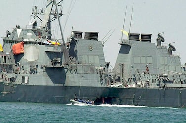 Experts in a speed boat examine the damaged hull of the USS Cole at the Yemeni port of Aden after an Al Qaeda attack that killed 17 sailors in October 2000. Dimitri Messinis / TAP Photo  