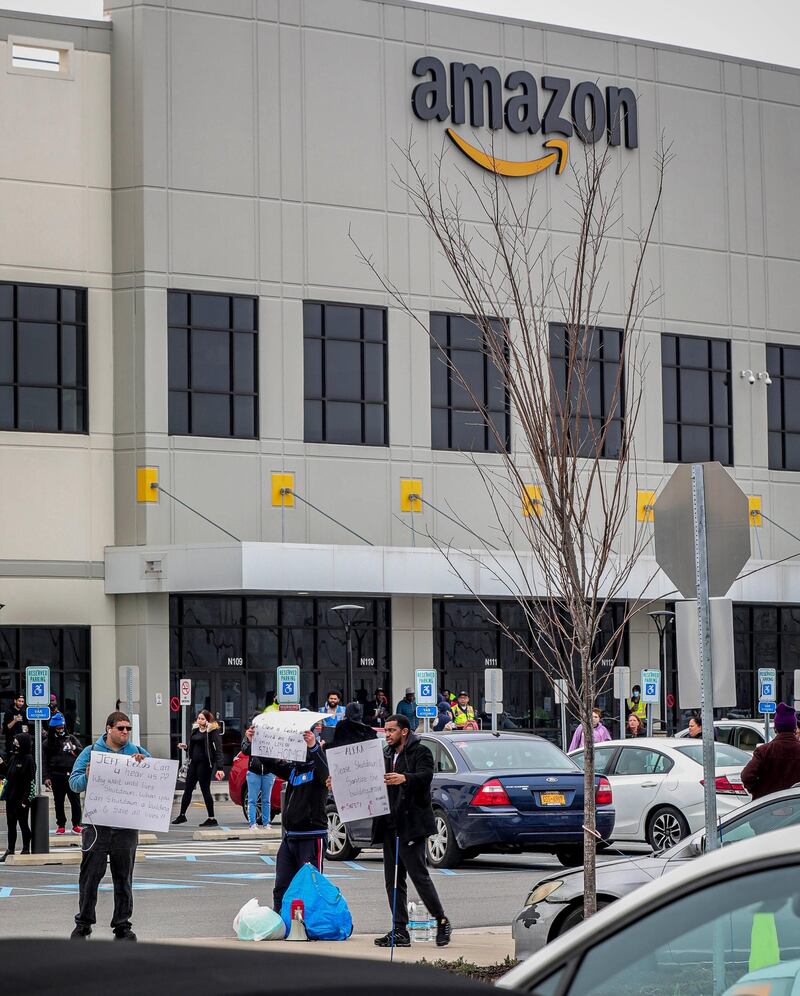 Workers at Amazon's fulfillment center in Staten Island, N.Y., protest work conditions in the company's warehouse, Monday March 30, 2020, in New York. Workers say Amazon is not doing enough to to keep workers safe from the spread of COVID-19 and coronavirus. (AP Photo/Bebeto Matthews)