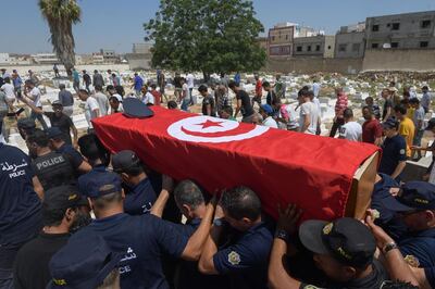 Police officers carry the coffin of a fellow officer, who was killed in yesterday's suicide attack on Habib Bourguiba avenue, during his funeral in the Sidi Hassine western suburb of the capital Tunis on June 28, 2019. Two blasts claimed by the Islamic State group killed a police officer in Tunis and wounded several other people on June 27, 2019. / AFP / FETHI BELAID
