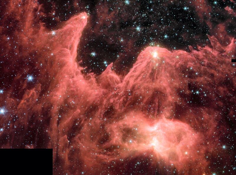 This majestic false-color image from NASA's Spitzer Space Telescope shows 'mountains' where stars are born. These towering pillars of cool gas and dust are illuminated at their tips with light from warm embryonic stars. NASA