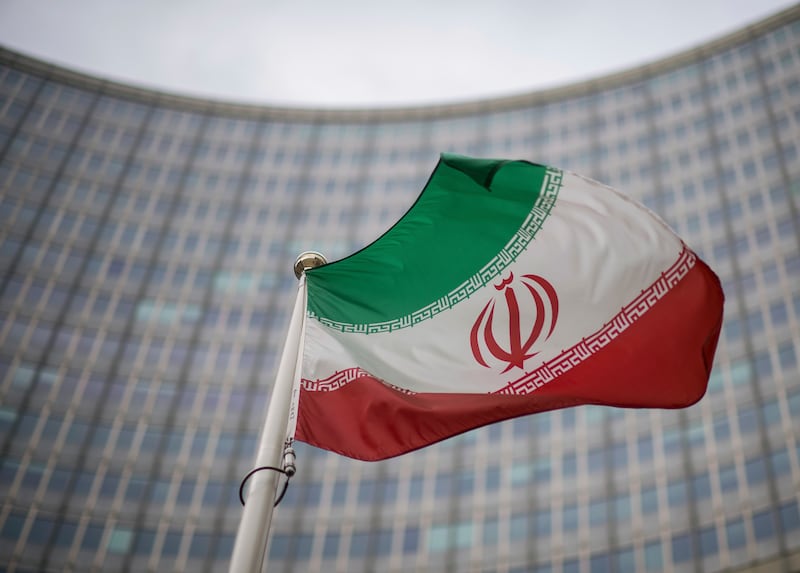 A national flag of Iran waves in front of the building of the International Atomic Energy Agency, IAEA, in Vienna, Austria. AP