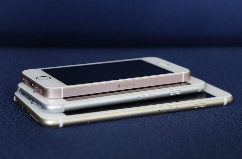 From bottom, the iPhone 6S Plus, 6S and SE lie stacked on one another. Julie Jacobson / AP Photo