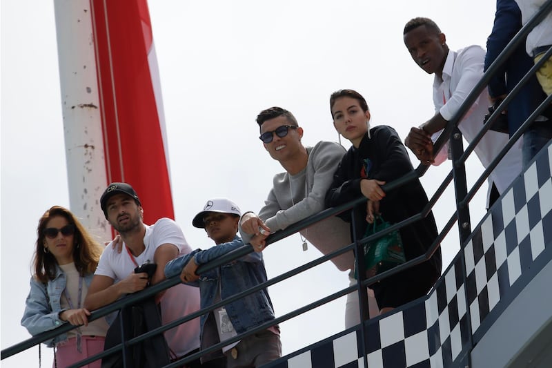 Cristiano Ronaldo, third right, with his partner Georgina Rodriguez, second right, and his son Cristiano Ronaldo Jr, watches the action. AP Photo