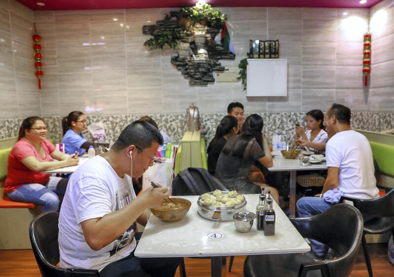 Abu Dhabi, U.A.E., July 4, 2018.    A customer enjoys his Lanzhou hand pulled noodles at the Dragon Bao Bao Cafeteria on Al Salama Street. Victor Besa / The NationalSection:  NAReporter:  Haneen Dajani