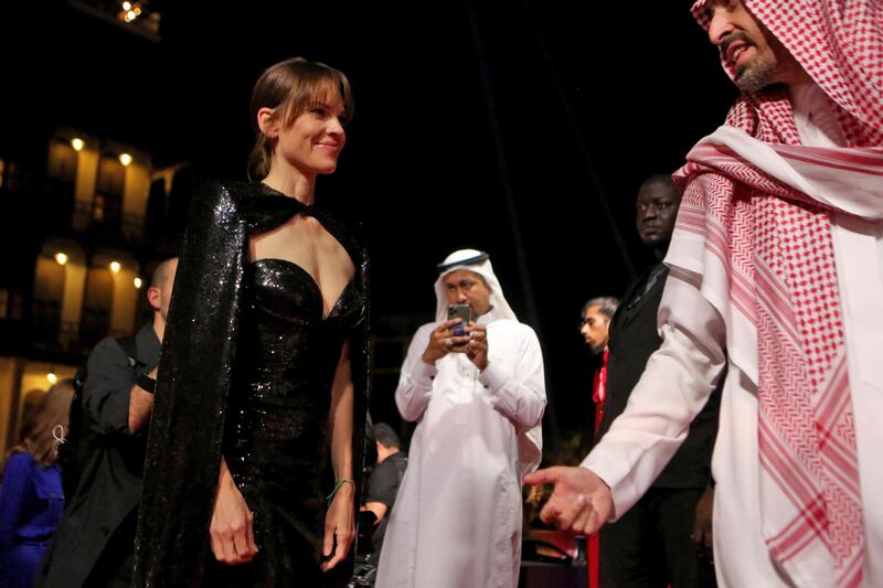 Actress Hillary Swank is greeted by Red Sea International Film Festival chairman Mohammed Al Turki on the opening night of the festival. AFP