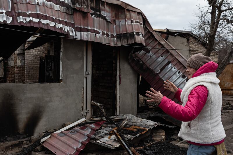 Svitlana, 62, shows a heavily damaged house in the residential area, in Hostomel, Ukraine. Getty Images