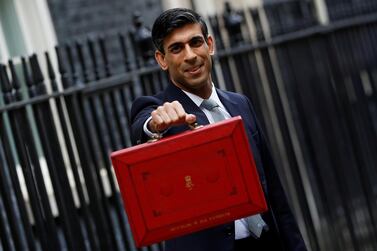 UK finance minister Rishi Sunak holds the budget box outside his office in Downing Street in London last year. Mr Sunak’s tax increase will see corporation tax rise sharply from its current rate of 19 per cent. Reuters