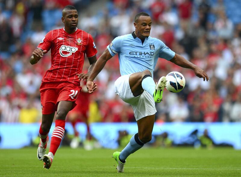 MANCHESTER, ENGLAND - AUGUST 19:   Vincent Kompany of Manchester City beats Guly Do Prado of Southampton to the ball during the Barclays Premier League match between Manchester City and Southampton at Etihad Stadium on August 19, 2012 in Manchester, England. (Photo by Shaun Botterill/Getty Images)