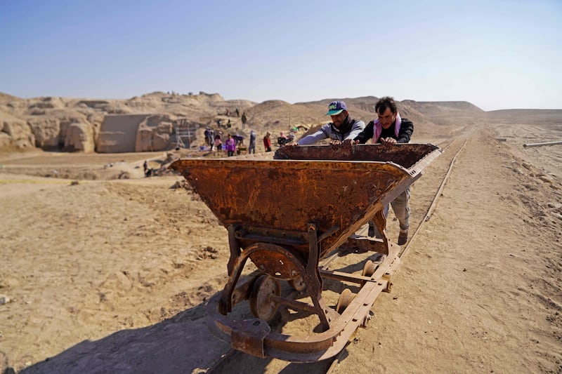 Workers use an old rail cart to carry material as they take part in a German-Iraqi archaeological expedition to restore the white temple of Anu in the Warka (ancient Uruk) site in Iraq's Muthanna province.