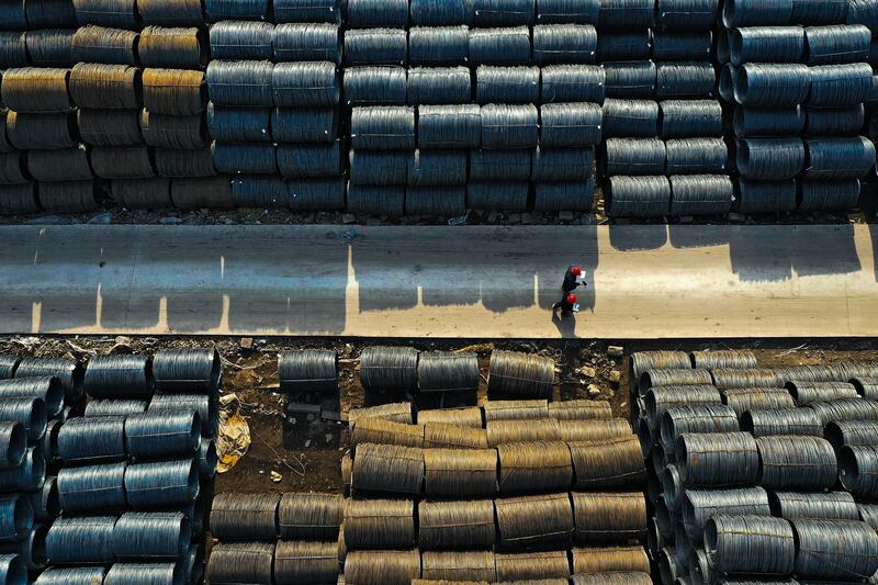People walking at a wholesale steel market in Shenyang, in northeastern China's Liaoning province. AFP