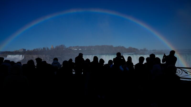 People are treated to a rainbow straddling Niagara Falls, Ontario. AP