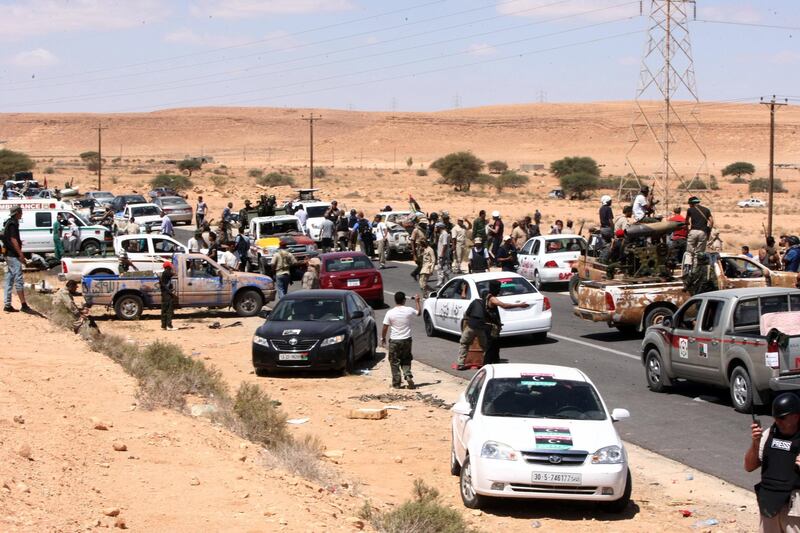 Libya's National Transitional Council (NTC) fighters gather about one  kilometre from outskirts of Bani Walid, southeast of Tripoli, on September 10, 2011 as the deadline expires for forces loyal to ousted Libyan strongman Moamer Kadhafi to surrender, with fighters of the country's new leadership poised to attack hold-out strongholds. AFP PHOTO/MAHMUD TURKIA
 *** Local Caption ***  796151-01-08.jpg