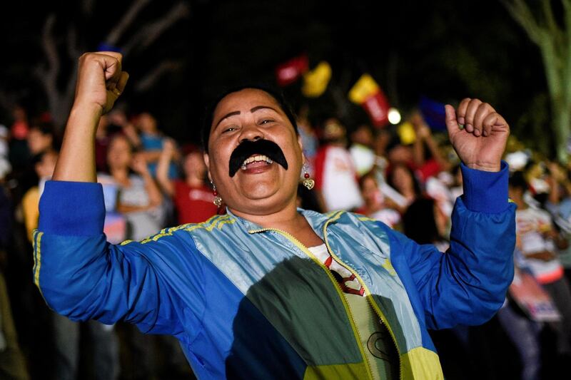 Supporters of the Venezuelan President Nicolas Maduro celebrate after the National Electoral Council announced the results of the voting on election day in Venezuela, in Caracas. Federico Parra / AFP