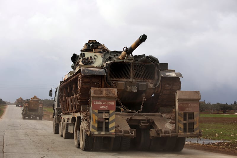 Turkish military convoy drives through the village of Binnish, in Idlib province, Syria, Feb. 8, 2020. AP