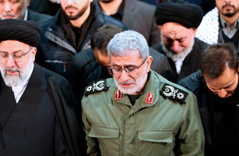 Newly appointed commander of Iran's Revolutionary Guards Quds Force, Gen Esmail Qaani, weeps while praying over the coffin of the force's previous head Qassem Suleimani at the Tehran University Campus in Tehran. AP
