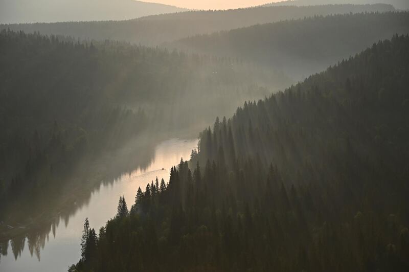 A boat sails along the Usva River during sunrise in Perm Region, Russia July 11, 2020. Picture taken July 11, 2020. REUTERS/Alexey Malgavko