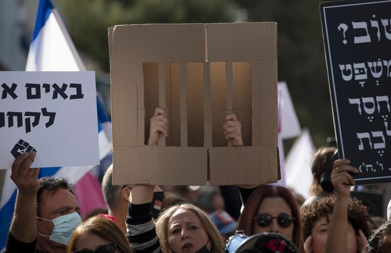 Thousands of Israelis protest against Mr Netanyahu outside the Jerusalem District Court. EPA