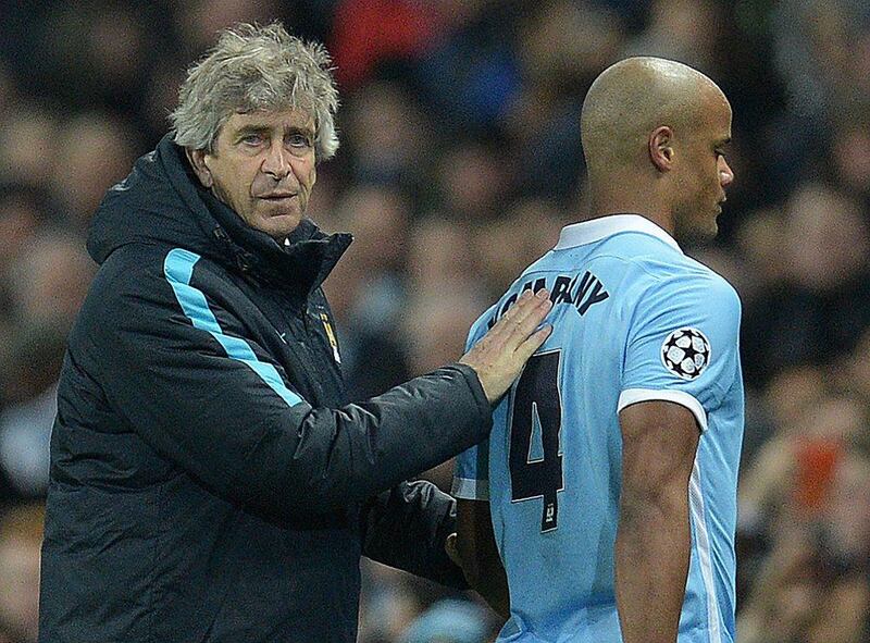 Manchester City’s Chilean manager Manuel Pellegrini (L) consoles Manchester City’s Belgian defender Vincent Kompany as he leaves the pitch injured during a Uefa Champions League last 16, second leg football match between Manchester City and Dynamo Kiev at the Etihad Stadium in Manchester, north west England, on March 15, 2016. AFP / OLI SCARFF