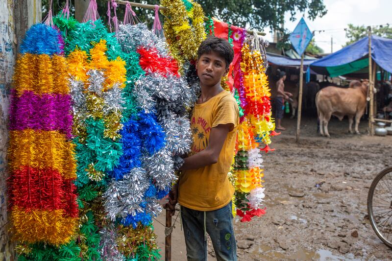 A vendor sells garlands for sacrificial animals near a  livestock market in Dhaka, Bangladesh. EPA