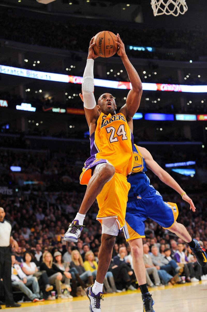 LOS ANGELES, CA - APRIL 12: Kobe Bryant #24 of the Los Angeles Lakers rises for a dunk against the Golden State Warriors at Staples Center on April 12, 2013 in Los Angeles, California. NOTE TO USER: User expressly acknowledges and agrees that, by downloading and/or using this Photograph, user is consenting to the terms and conditions of the Getty Images License Agreement. Mandatory Copyright Notice: Copyright 2013 NBAE   Noah Graham/NBAE via Getty Images/AFP