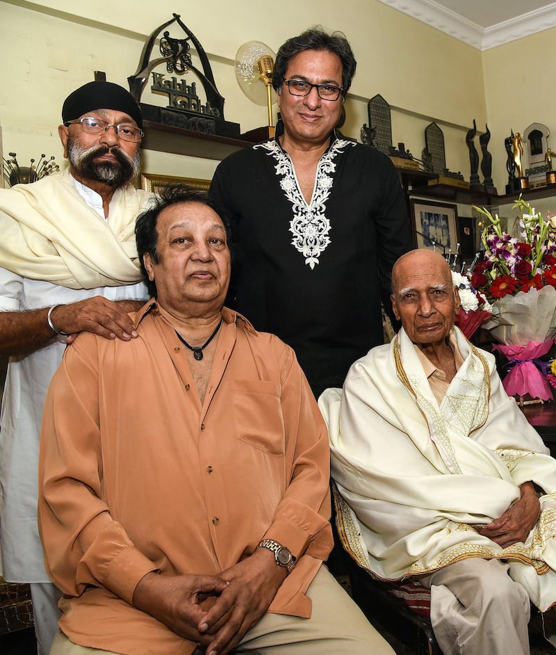 Indian music director Uttam Singh (left), singer Talat Aziz (right), musician and singer Bhupinder Singh (seated left) celebrate the 92nd birthday of Bollywood music director and composer Mohammed Zahur Khayyam (seated right), better known as Khayyam, at his home in Mumbai on February 18, 2019.  AFP