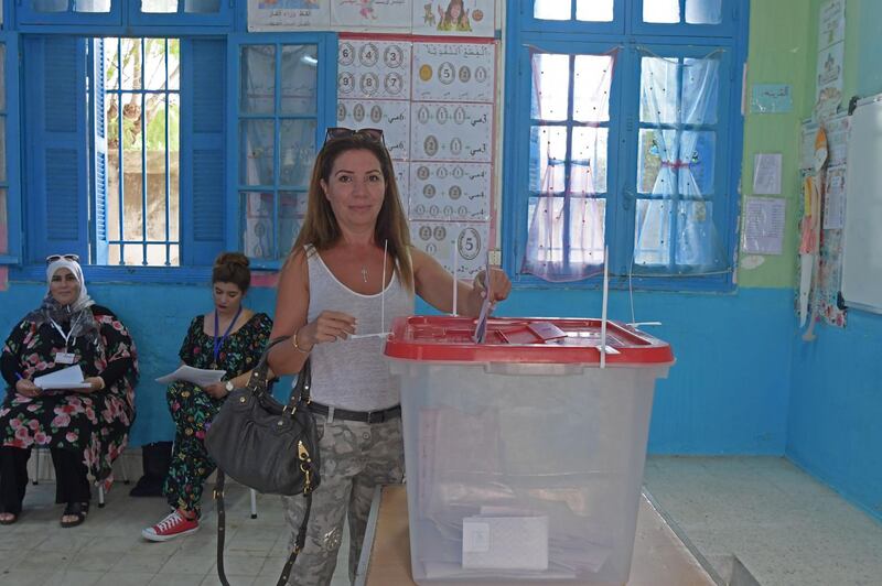 A Tunisian voter casts her ballot for presidential elections at a polling station in La Marsa on the outskirts of the capital Tunis. Rarely has the outcome of an election been so uncertain in Tunisia, the cradle and partial success story of the Arab Spring, as some seven million voters head to the polls today to choose from a crowded field.  AFP