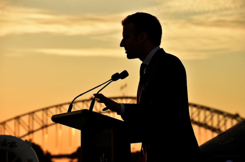 The silhouette of French president Emmanuel Macron as he speaks during a defence strategic partnership event on board the Australian aircraft carrier HMAS Canberra in Sydney. Peter Parks / EPA