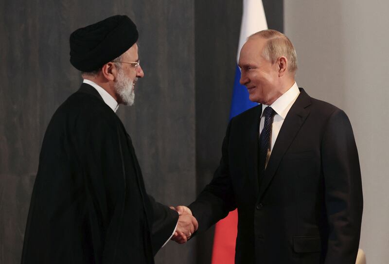 Russian President Vladimir Putin shakes hands with Iranian President Ebrahim Raisi during a meeting on the sidelines of the Shanghai Co-operation Organisation summit in Samarkand, Uzbekistan, on Thursday. Reuters