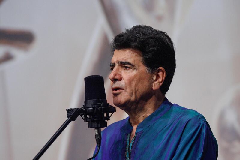 CORRECTION / This picture taken on October 20, 2008 shows Iran's legendary singer, instrumentalist, and composer Mohammad-Reza Shajarian singing before a microphone in the capital Tehran. Shajarian, who embodied traditional and classical music in Iran, died in Tehran on October 8, 2020 after a long battle with illness, his son said. - 
 / AFP / ISNA / Alireza SOTAKBAR
