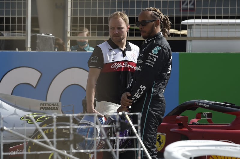 Lewis Hamilton speaks with Alfa Romeo driver Valtteri Bottas. AFP