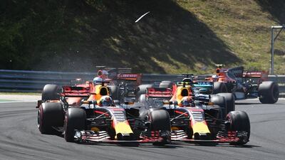 Daniel Ricciardo, left, and Red Bull Racing teammate Dutch Max Verstappen collide on the first lap of the Hungarian Grand Prix. Andrej Isakovic / AFP