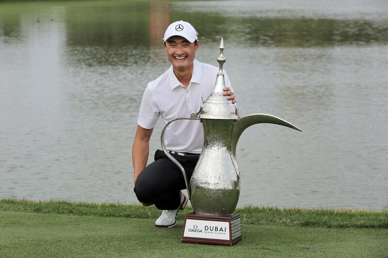 epa06481242 Li Haotong of China poses with the trophy following his victory in the Dubai Desert Classic 2018 golf tournament in Dubai, United Arab Emirates, 28 January 2018.  EPA/MAHMOUD KHALED