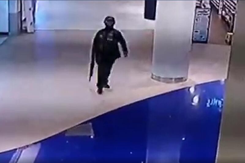 A video grab created from a handout video released by the MCOT Thai Public Company Limited shows CCTV footage of Thai soldier Jakrapanth Thomma holding a gun as he walks through the Terminal 21 shopping mall in Nakhon Ratchasima. AFP