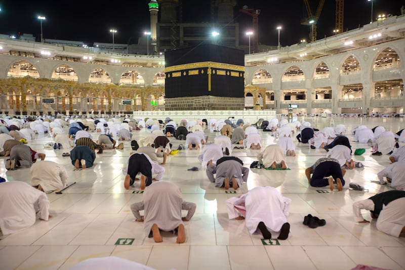 Pilgrims pray in the evening near the Kaaba.