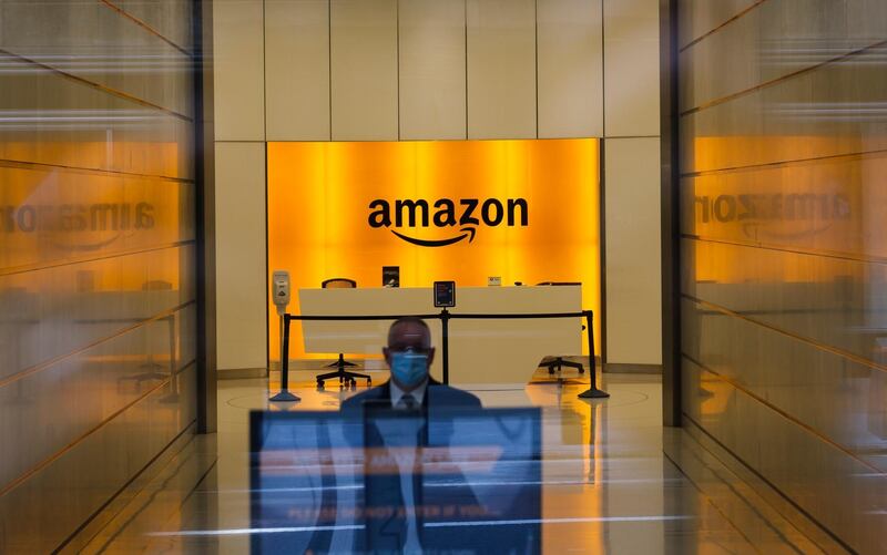 epa08873753 (FILE) A man is seen inside the entrance to the Amazon offices in New York, New York, USA, on 27 May 2020 (reissued 10 December 2020). According to media reports on 10 December 2020, French data privacy regulator CNIL will impose over 100 million euros fines on US companies Google and Amazon for breaching EU privacy data rules. According to media reports, Google will have to pay 100 million euros and Amazon 35 million euros fines.  EPA/HAYOUNG JEON *** Local Caption *** 56200286