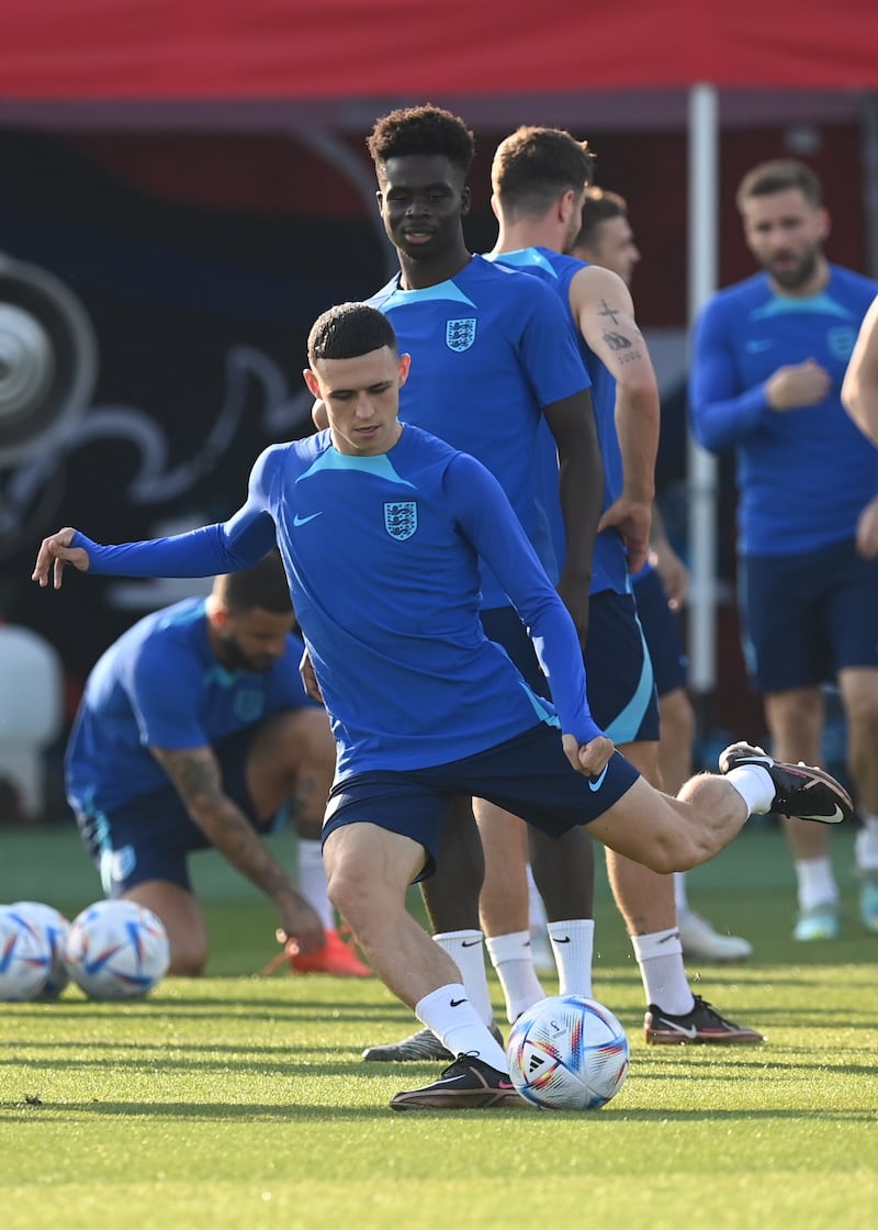 Phil Foden is watched by teammate Bukayo Saka. EPA