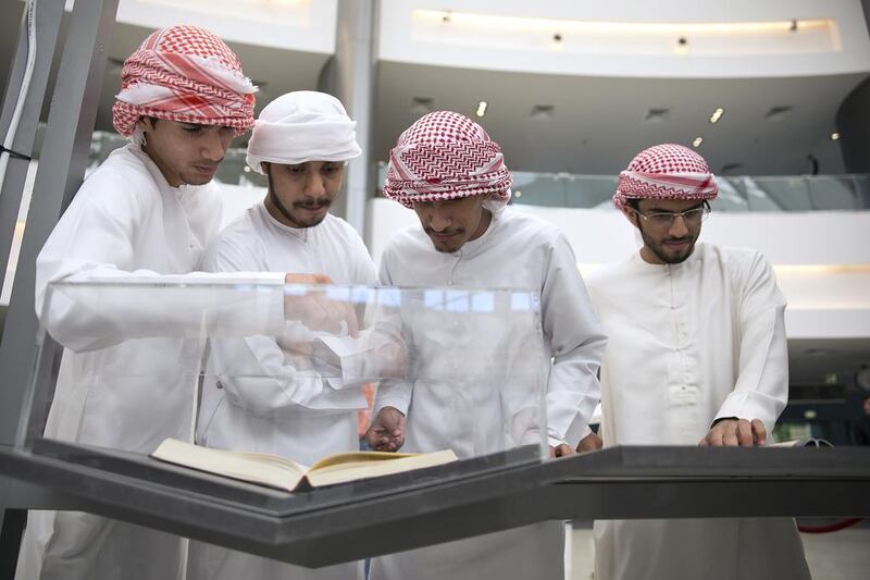 Al Ittihad High School students, (top, from left) Ammar Al Shehli, Aisa Al Romathi, Rashid Al Mazrouei and Mohammed Al Marzooqi, check out the artefacts as they tour the Golden Age of Arab Science exhibition at Paris-Sorbonne University Abu Dhabi. The exhibition highlights the evolution of science in the golden age of the Arab and Islamic civilisation and celebrates the outstanding contributions made by Arab and Islamic pioneers. Silvia Razgova / The National