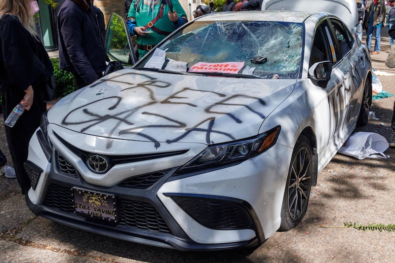 A car is damaged after it was driven towards protesters at Portland State University. AFP