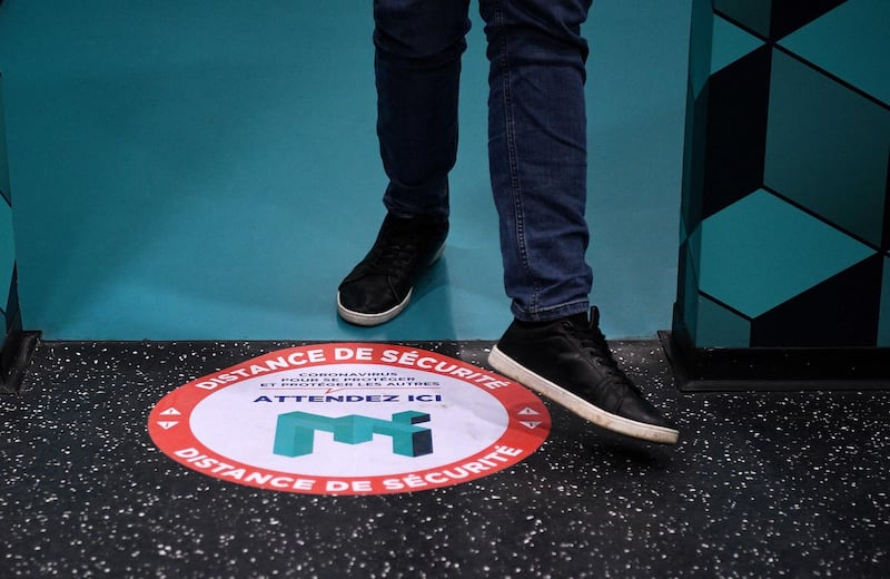 Social distance markers are placed on the floor of the Museum of Illusion in Paris, advising visitors to keep a safe six-foot distance from each other.  AFP
