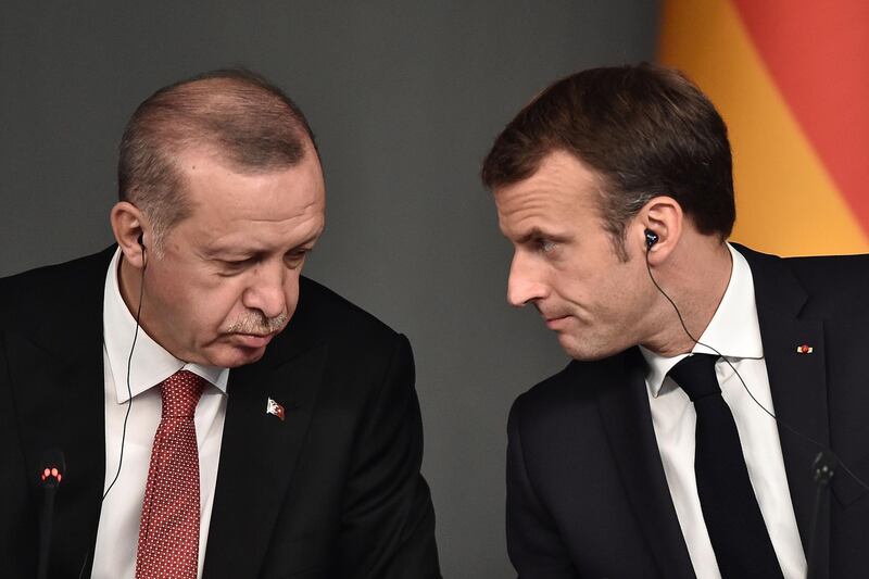 (FILES) In this file photo taken on October 27, 2018, Turkish President Recep Tayyip Erdogan (L) and President Emmanuel Macron attend a conference as part of a summit called to attempt to find a lasting political solution to the civil war in Syria which has claimed in excess of 350 000 lives, at Vahdettin Mansion in Istanbul. The French government will summon the Turkish envoy in Paris for talks after what it termed "insults" by Turkey's President Recep Tayyip Erdogan, who accused Emmanuel Macron of suffering "brain death", the president's office said on November 29, 2019. / AFP / OZAN KOSE
