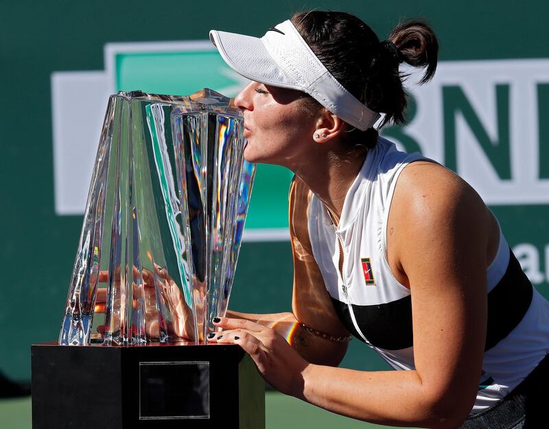 epa07446056 Bianca Andreescu of Canada kisses the trophy after winning against Angelique Kerber of Germany during the Finals at the BNP Paribas Open tennis tournament at the Indian Wells Tennis Garden in Indian Wells, California, USA, 17 March 2019.  EPA/JOHN G MABANGLO