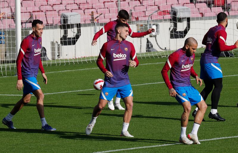 Barcelona's Dani Alves, Ferran Torres and Sergio Busquets during training at Camp Nou on Monday. Reuters