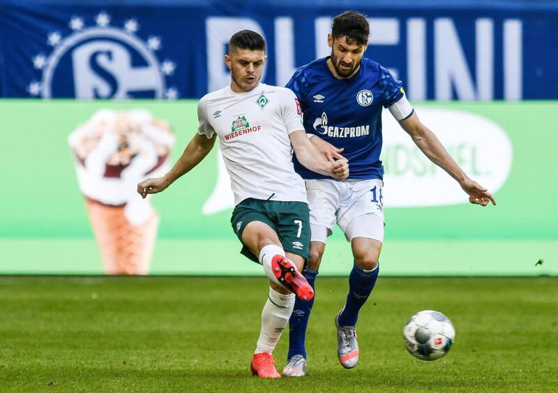 Werder Bremen's Milot Rashica passes the ball  under pressure from Daniel Caligiuri of Shalke. Reuters