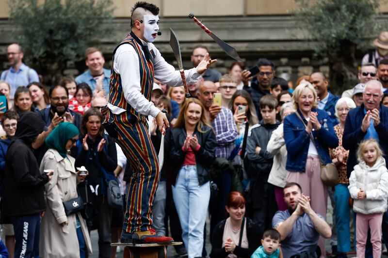 Throughout Fringe, Edinburgh's Royal Mile hosts a varied array of artists and entertainers, ranging from opera singers to circus performers. Getty Images