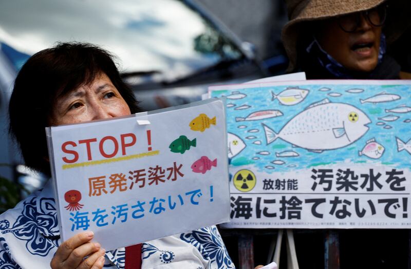 A protester holds a sign that reads "Don't throw radiation-contaminated water into the sea", during a rally against discharging of treated radioactive water the ocean, in front of Prime Minister Fumio Kishida's official residence in Tokyo, Japan, on August 25. Reuters