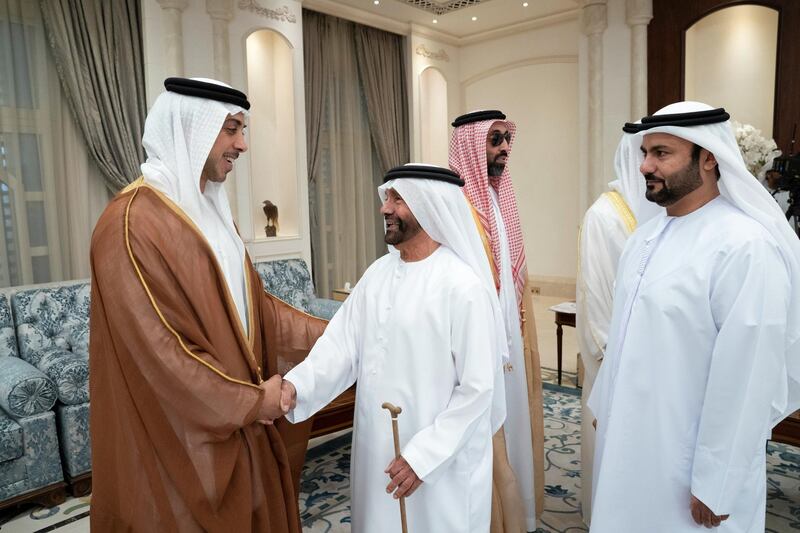 ABU DHABI, UNITED ARAB EMIRATES - June 04, 2019: HH Sheikh Mansour bin Zayed Al Nahyan, UAE Deputy Prime Minister and Minister of Presidential Affairs (L), greets Humaid bin Dalmouch Al Dhaheri (2nd L), during an Eid Al Fitr reception at Mushrif Palace. Seen with HH Sheikh Tahnoon bin Zayed Al Nahyan, UAE National Security Advisor (3rd L).

( Mohamed Al Hammadi / Ministry of Presidential Affairs )
---