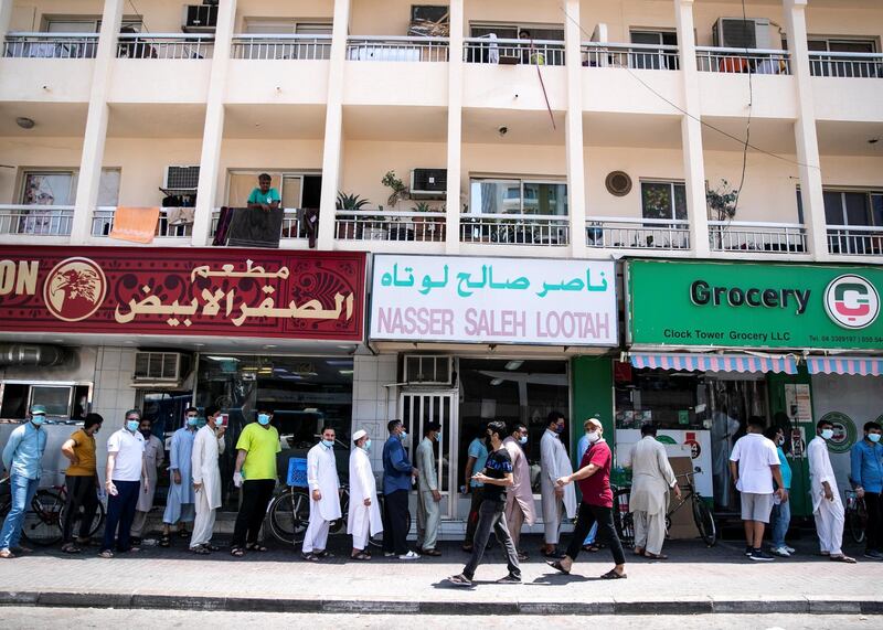 DUBAI, UNITED ARAB EMIRATES. 18 June 2020. 
Pakistani citizens who live in Dubai line up outside Dnata. They’ve received a confirmation call from the consulate regarding their repatriation flights. Some are flying back tonight.
(Photo: Reem Mohammed/The National)

Reporter:
Section: