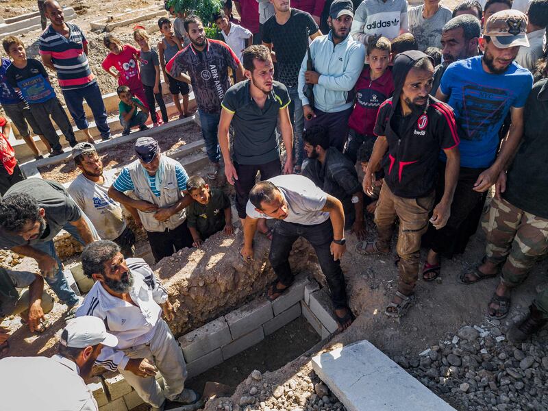 Mourners prepare a grave for a fighter from the pro-Turkish Hamza Division Syrian rebel group killed in a Russian air raid. The strikes hit a school used as a military base outside the north Syria town of Afrin. AFP