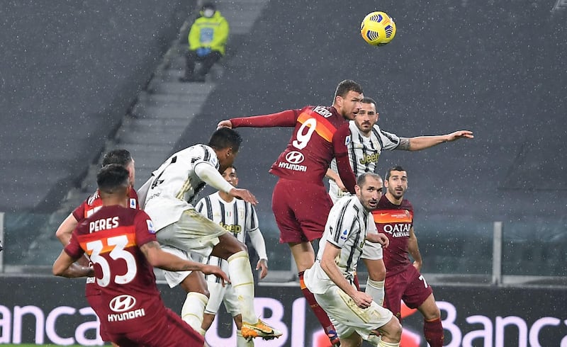 Roma striker Edin Dzeko wins a header. EPA